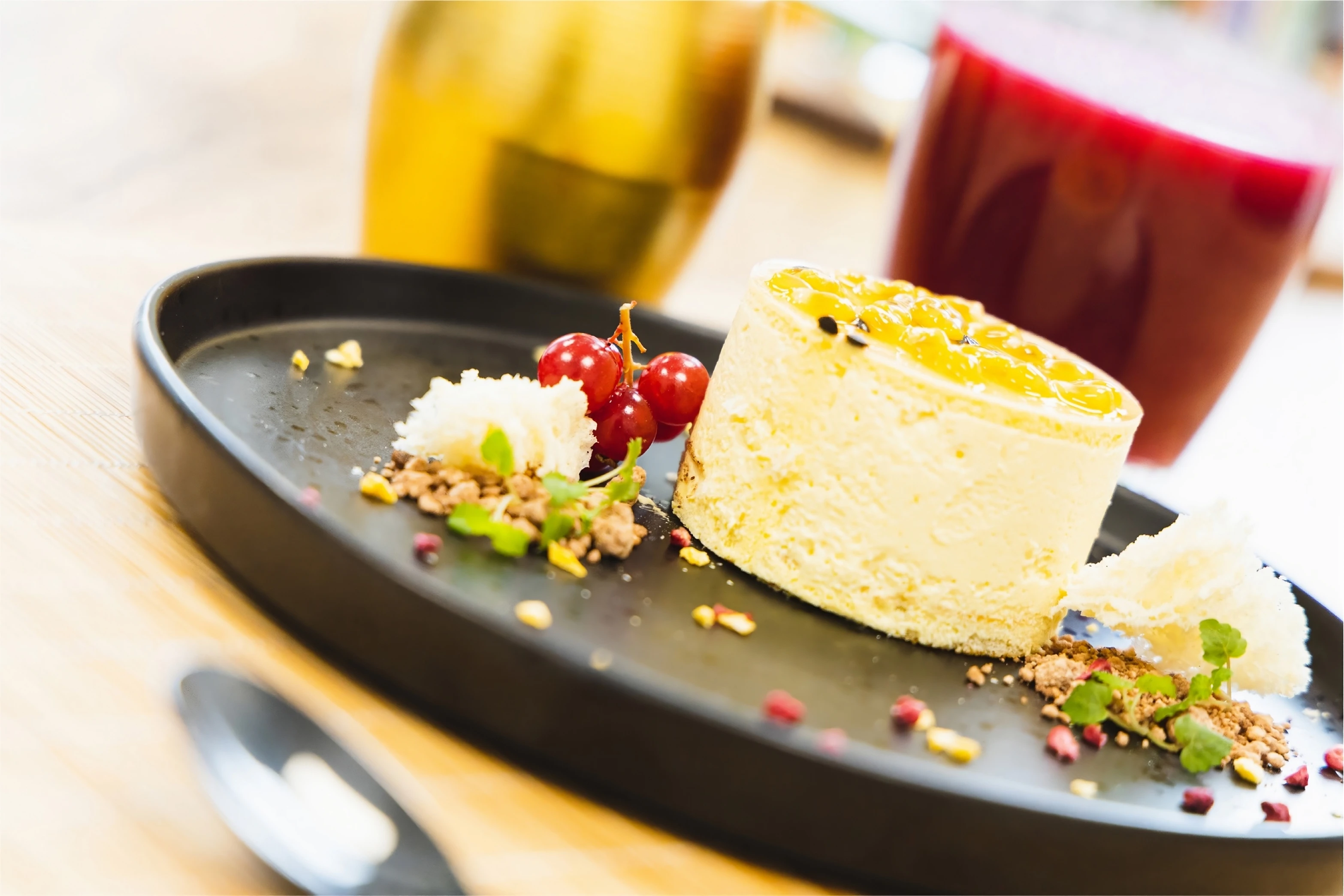 Artistic close up of vanilla panna cotta on a table with drinks.