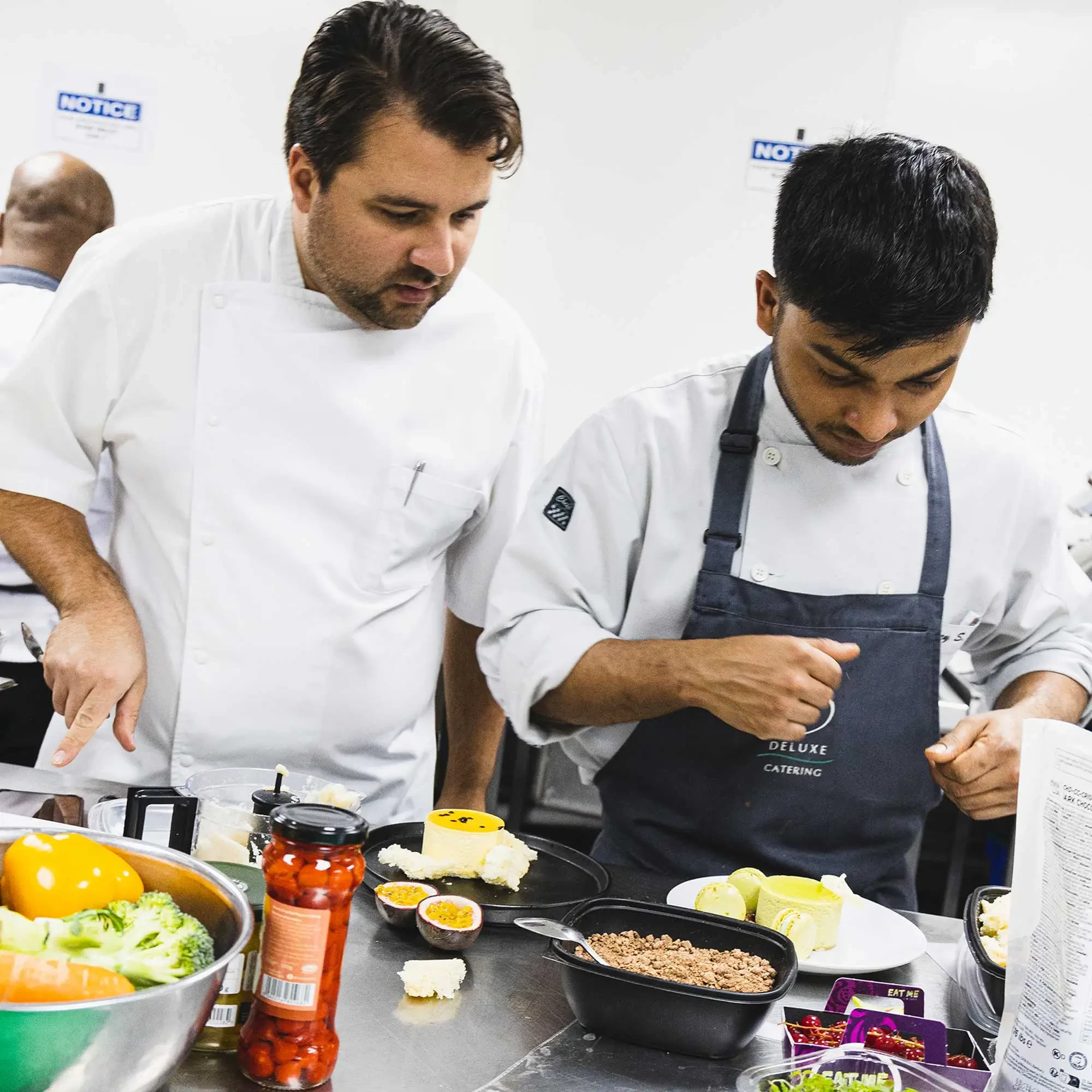 Two male chefs preparing food.