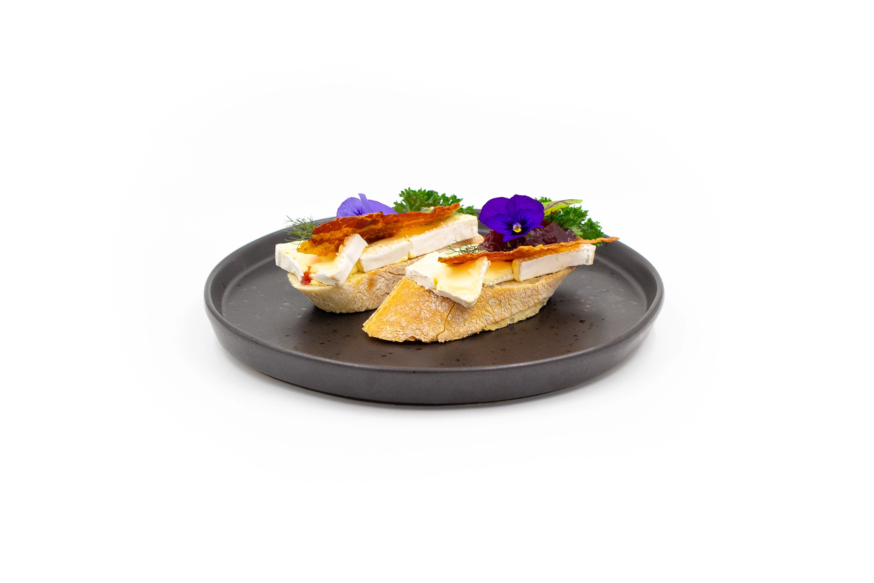 Open sandwich with creamy brie, crispy streaky bacon and cranberry sauce